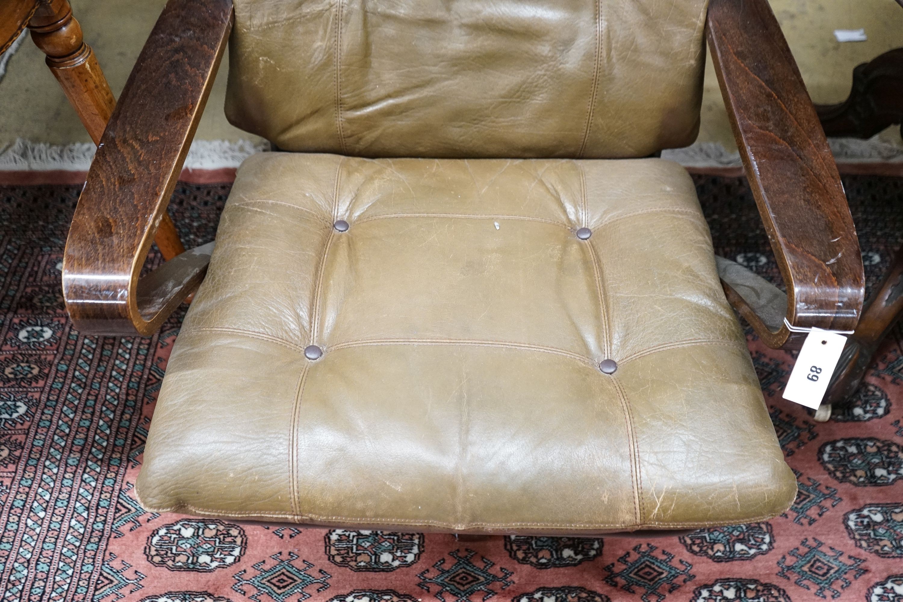 A mid century swivel chair with leather cushion upholstery, width 77cm, depth 75cm, height 94cm